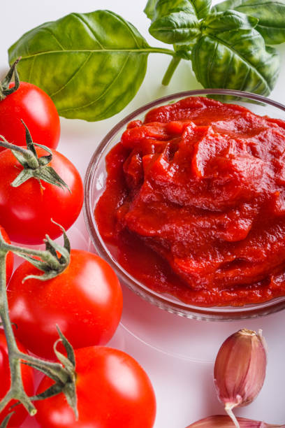 fresh natural tomato paste on a white background.