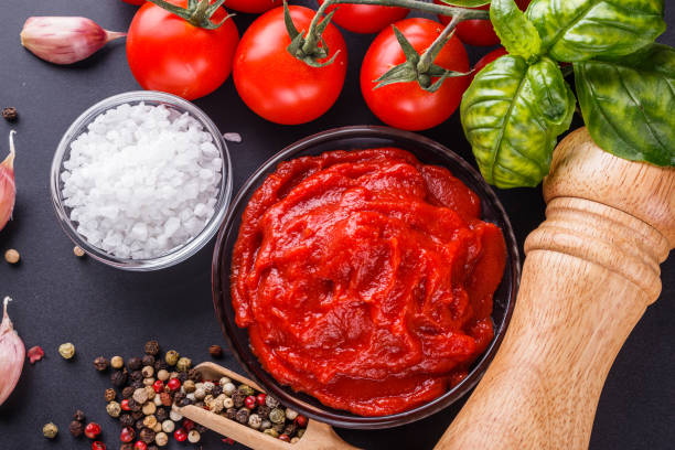 fresh natural tomato paste on black background.