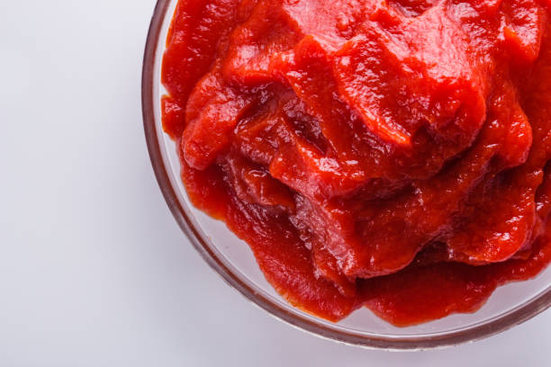 fresh natural tomato paste on a white background.