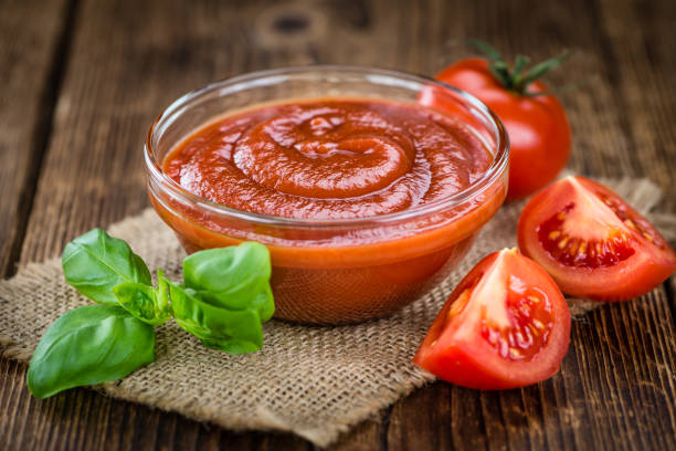 Portion of fresh made Tomato Ketchup (close-up shot; selective focus)
